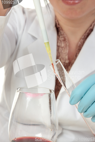 Image of Forensic scientist taking sample from glass