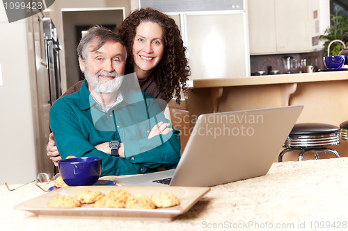 Image of Father and daughter using laptop