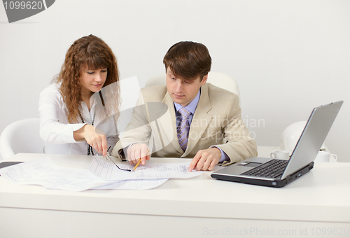 Image of Pair of young businessmen in workplace