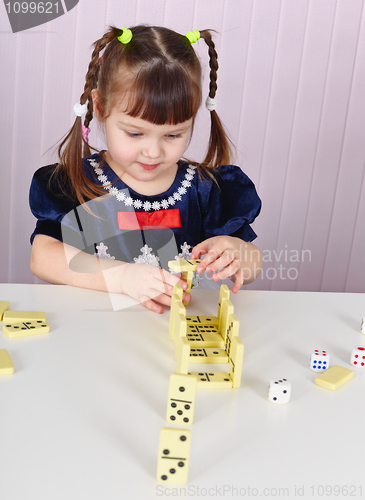 Image of Child plays with toys at table