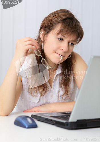 Image of Woman reading from screen of laptop