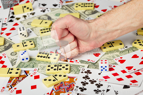 Image of Hand clenched in a fist and playing cards