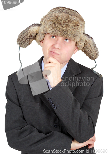 Image of Young man in a fur hat dreams on white background