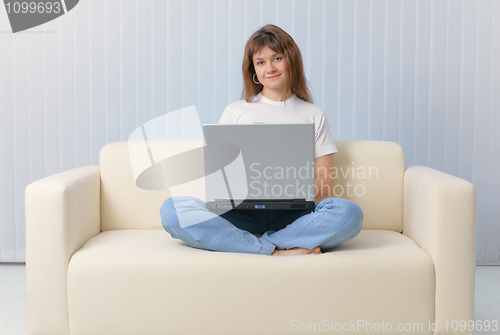 Image of Girl sitting on couch with a laptop