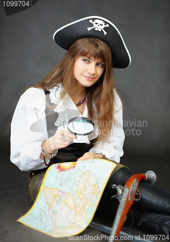 Image of Girl - pirate sitting with a map and magnifying glass