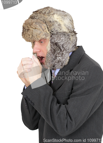 Image of Freezing businessman in fur hat on white background