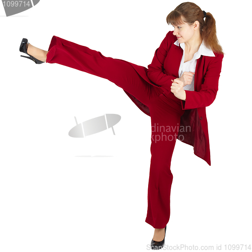 Image of Beautiful girl in business suit kicks