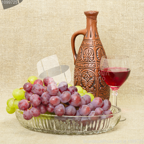 Image of Still life with ceramic bottle, grape and glass