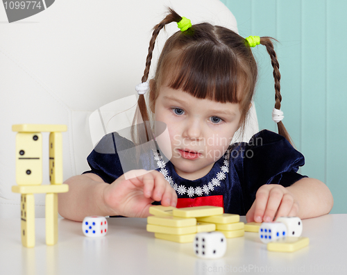 Image of Child playing with small toys at table