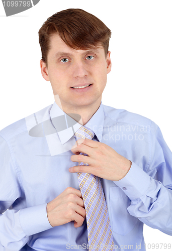 Image of One young man arranges his tie on white