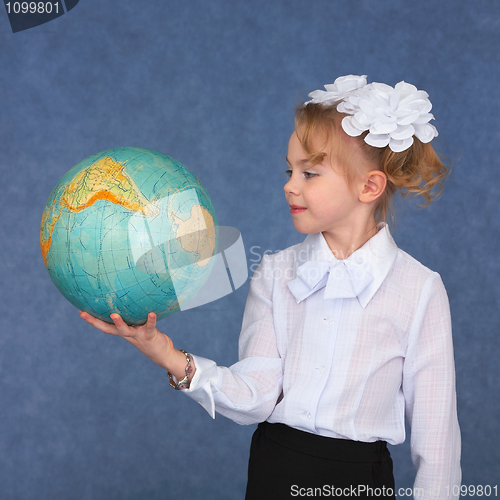 Image of Schoolgirl looking at a geographical globe