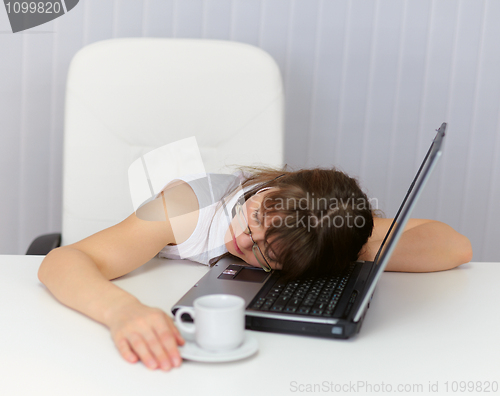 Image of Woman was tired and sleeping on keyboard of laptop