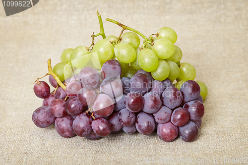 Image of Red and green grapes on canvas background