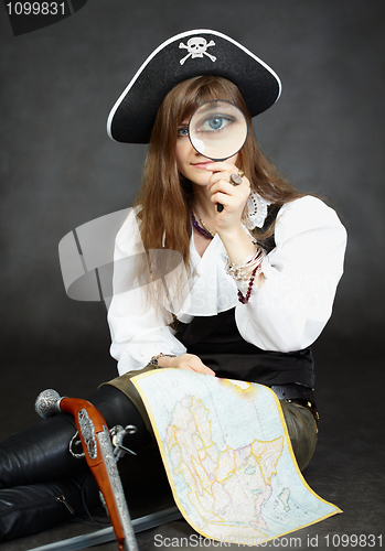 Image of Woman pirate, and map with a magnifying glass on black backgroun