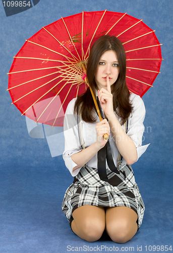 Image of Girl with red oriental umbrella on blue