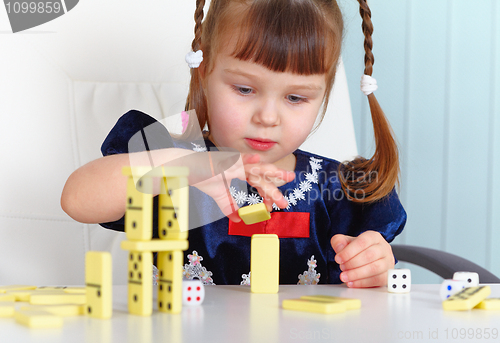 Image of Child playing with dominoes