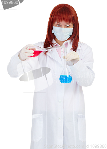 Image of Woman scientist mixes colored chemical solutions