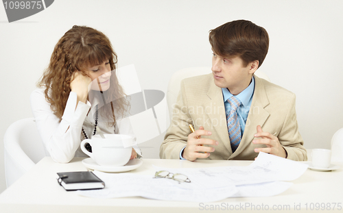 Image of Woman has got tired and falls asleep on a workplace