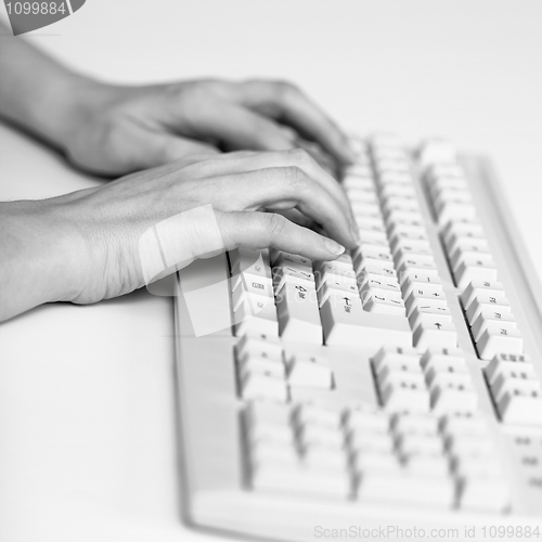 Image of Two hands prints on computer keyboard