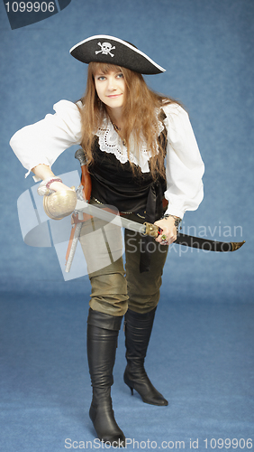 Image of Young woman in clothes of pirate on blue background