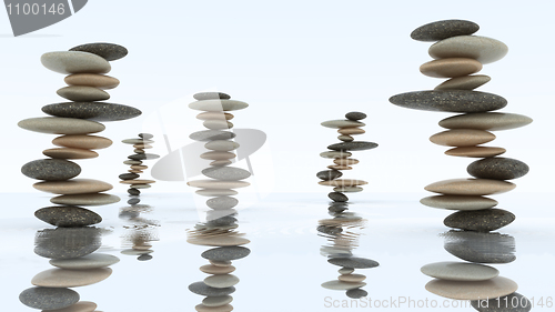 Image of Stability and harmony. Pebble stacks on water