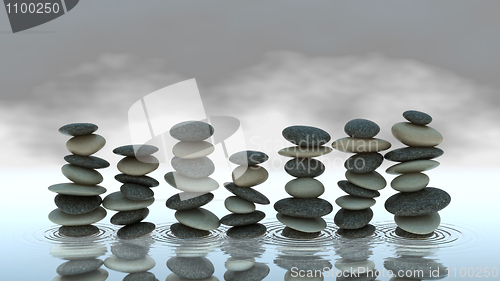 Image of Group of Pebble stacks on water level