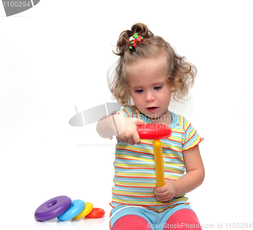 Image of cute little girl playing with pyramid