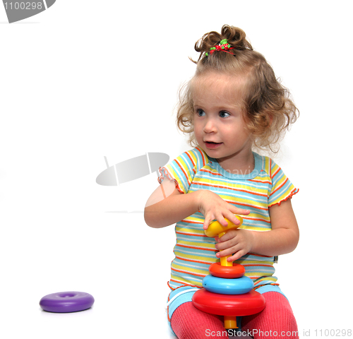 Image of cute little girl playing with pyramid