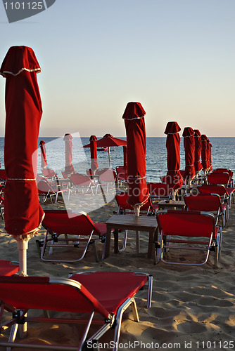 Image of Red Sunshades And Sunbeds