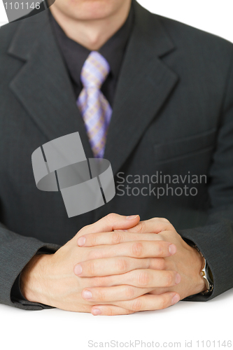 Image of Hands of businessman lying on table