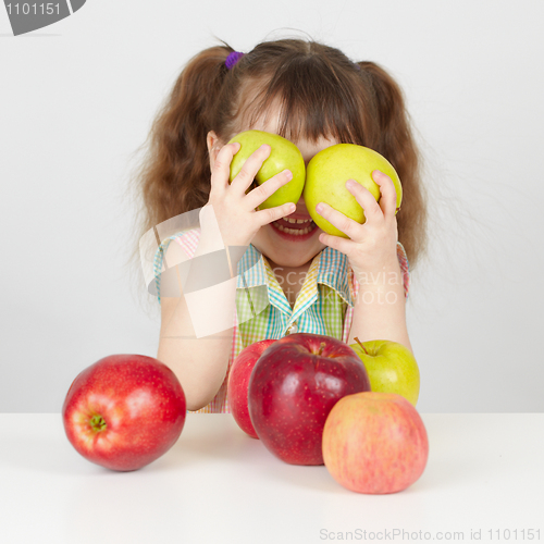 Image of Funny child playing with two apples