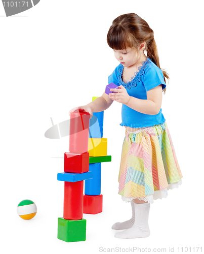 Image of Girl build a tower of toy bricks