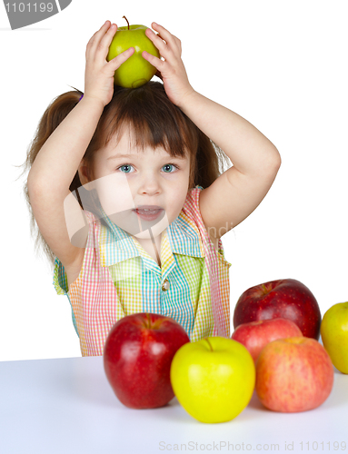 Image of Little girl plays with fruit - apples