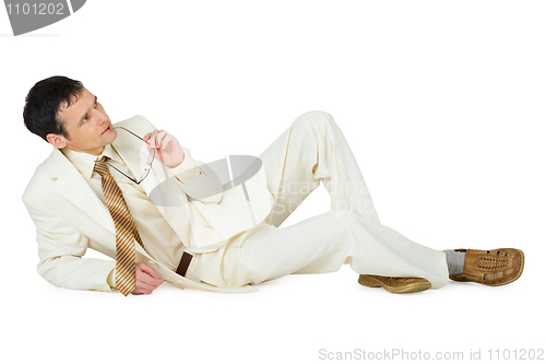Image of Thinking young man lies