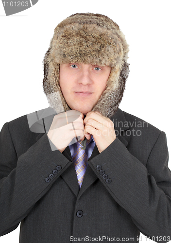 Image of Man puts on head a fur hat