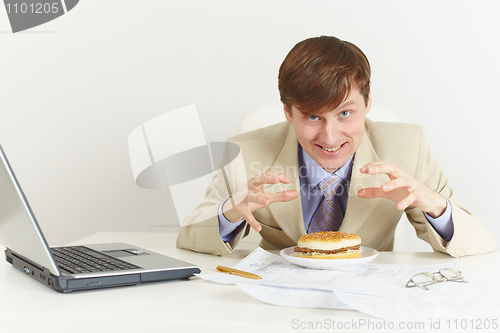 Image of Young hungry man is going to eat a sandwich