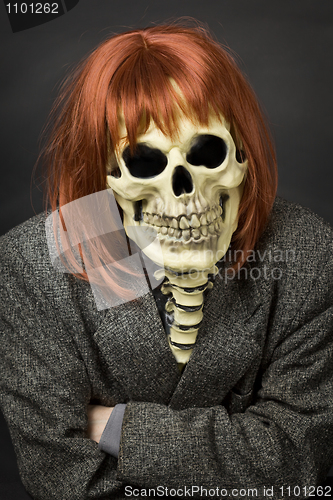 Image of Person in mask of death and red wig