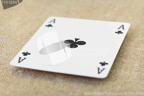 Image of Ace of spades lies on table covered with fabric
