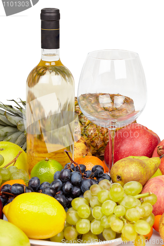 Image of Still life - bottle of wine, glass and tropical fruit