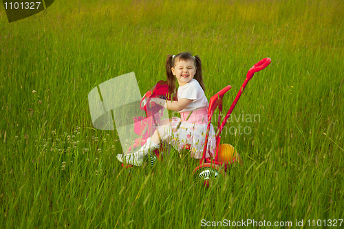 Image of Comical child on a bicycle - grimace