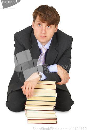 Image of Young erudition man with stack of books