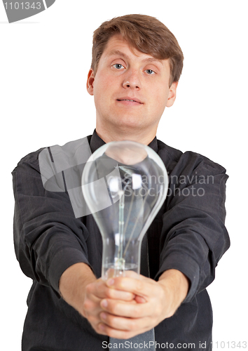 Image of Young man with electric bulb in hands