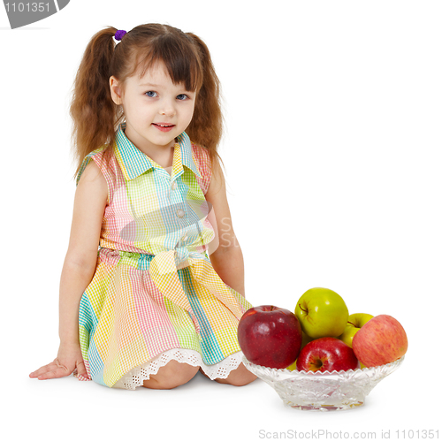 Image of Little girl and dish filled with apples