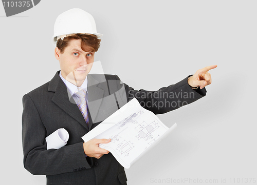 Image of Young engineer - building specialist in helmet with drawing