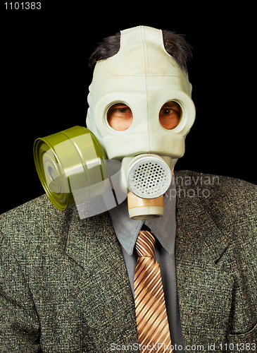 Image of Portrait of person in a gas mask on black background