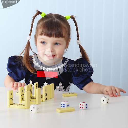 Image of Smiling girl sitting at table