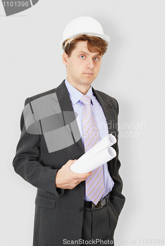 Image of Young engineer - building specialist in helmet