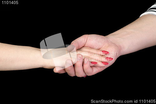 Image of Female hand in a man's hand on a black