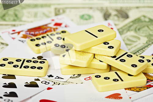 Image of Handful of dominoes on cards and money