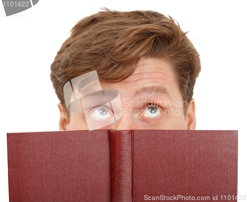 Image of Man dreamily reading book - close-up of eyes